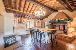 a kitchen with a large island with bar stools at Glicine in Montieri