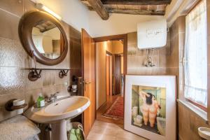 a bathroom with a sink and a mirror at Glicine in Montieri +24 photos