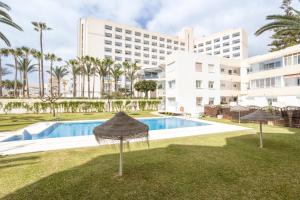 a resort pool with a hotel in the background at Torresol 208 in Nerja