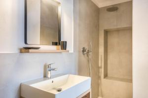 a bathroom with a sink and a mirror and a shower at Eichhof Apartment Thymian in Termeno +13 photos