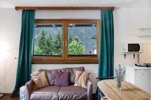a living room with a couch and a window at Sonnberg in Stall