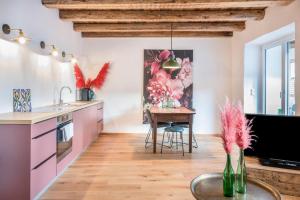 a kitchen with a table and a dining room at Eichhof Apartment Thymian in Termeno