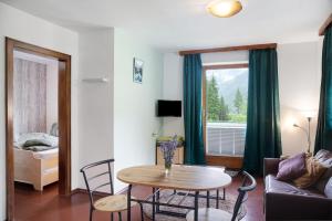 a living room with a table and a couch at Sonnberg in Stall