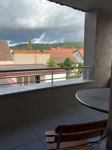 a balcony with a table and a view of a city at Bio Bausewein - No.2 Apartment in Iphofen