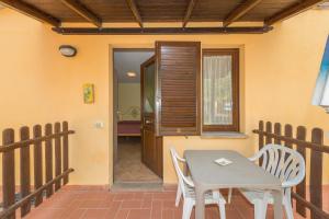 a patio with a table and chairs on a balcony at Il Girasole - Cappero in Venturina Terme