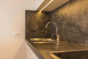 a kitchen sink with a faucet on a counter at Rosalpina Apt 4 in San Vigilio Di Marebbe +18 photos