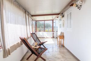 a room with two chairs and a table in front of a window at Casa Cantina Scalecci in Noto