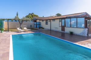 a swimming pool in the backyard of a house at Casa Cantina Scalecci in Noto