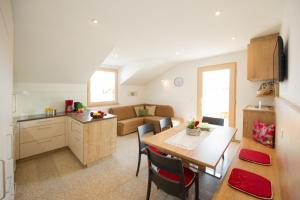 a kitchen and a living room with a table and chairs at Kristallhof Fewo Bergblick in Caldaro