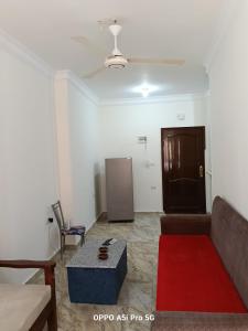 a living room with a couch and a table at 2 rooms, 2 balconies in Marsa Alam City