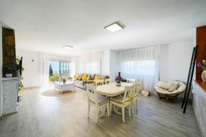 a living room with a table and chairs and a couch at Villa Mar in Teià