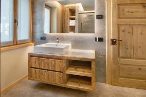 a bathroom with a sink and a mirror at Casa Ronden Mortirolo in Mazzo di Valtellina +43 photos
