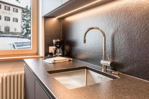 a kitchen counter with a sink and a window at La Grambla App Sella 1 in Santa Cristina Gherdëina +25 photos