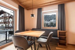 a dining room with a table and chairs and a window at La Grambla App Sella 1 in Santa Cristina Gherdëina