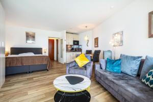 a living room with a couch and a bed at Apartementhaus Lord Nelson in Cuxhaven +28 photos