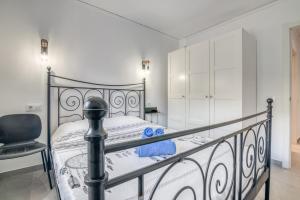 a bedroom with a black bed and a chair at Casa Julieta in Benitachell +17 photos