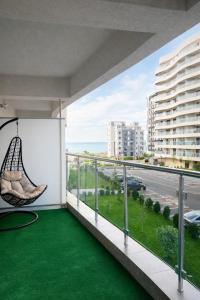 a balcony with a hammock and a view of the ocean at Ametist in Mamaia