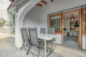 a dining room with a white table and chairs at Casa Julieta in Benitachell