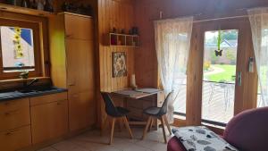 a kitchen with a desk and chairs and a window at Ferienhaus Burg Celle in Celle +16 photos
