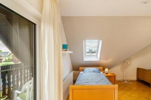 a small bedroom with a bed and a window at Ferienwohnung an der Ohme in Warburg