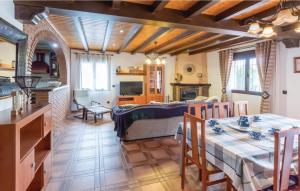 a bedroom with a bed and a dining room with a table at Casa Olivia in Cómpeta