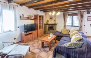 a living room with a couch and a tv at Casa Olivia in Cómpeta