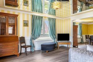 a living room with a bed and a tv at Ferienhaus Barockhaus Fulda in Petersberg