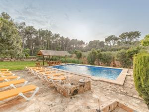 an outdoor pool with lounge chairs and a swimming pool at El Bosque in Llucmajor