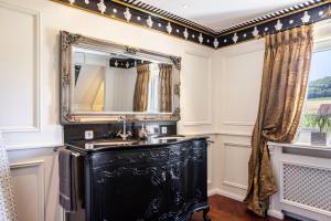 a bathroom with a black sink and a mirror at Ferienhaus Barockhaus Fulda in Petersberg +29 photos