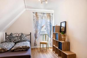 a bedroom with a bed and a book shelf at Ferienhaus Barockhaus Fulda in Petersberg