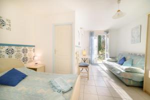 a living room with a bed and a couch at Chambres D'hôtes in Saint-Cyprien