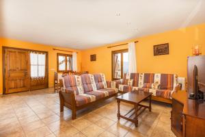 a living room with couches and a table at Xisqueta in Campo