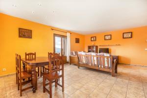 a dining room with yellow walls and a table and chairs at Xisqueta in Campo +18 photos