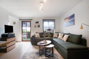 a living room with a couch and a table at Ferienwohnung Reindler in Fischen