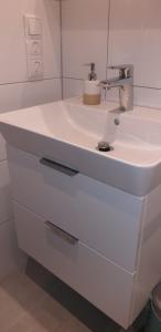 a bathroom with a white sink in a room at Ferienwohnung Reindler in Fischen +14 photos