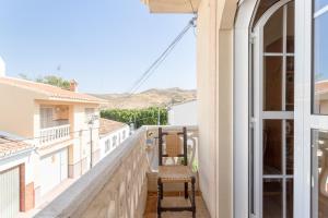a balcony with a view of a house at Planta uno Valle de Abdalajis in Valle de Abdalagís