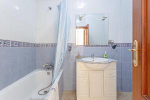 a bathroom with a tub and a sink and a mirror at Planta uno Valle de Abdalajis in Valle de Abdalagís +13 photos