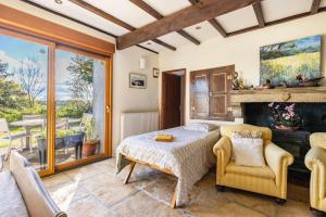 a bedroom with a bed and a fireplace at Bourdeverre Chambres D'hôtes in Sanxay