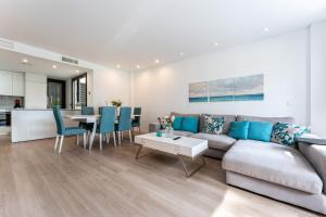 a living room with a couch and a table at 206 Navigolf 3 in La Cala de Mijas