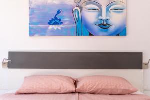 a painting above a bed with a pink pillow at 206 Navigolf 3 in La Cala de Mijas +15 photos