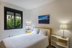 a white bedroom with a bed and a window at Lujan 3c Entre Cielo Y Mar in Puntallana