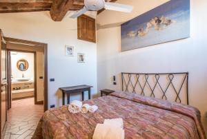 a bedroom with a bed with two shoes on it at Appartamento Gemma Bianca-tavoleto in Castiglione dʼOrcia