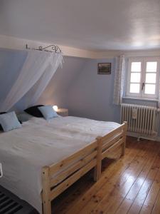 a bedroom with a large bed with white sheets at Ferien- und Gästehaus Jockgrim in Jockgrim