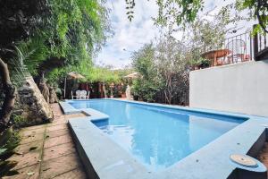 a swimming pool in a yard with trees at Navila Pasillo Superior in Ibiza Town