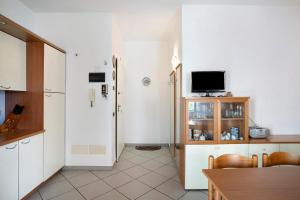 a kitchen with a table and a tv in it at Mirafiori in Alassio +11 photos
