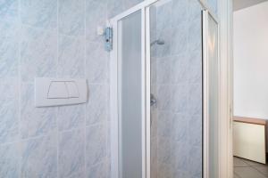 a shower with a glass door in a bathroom at Mirafiori in Alassio