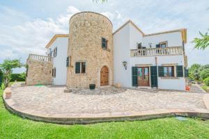 an exterior view of a house with a tower at Casa Verde in Sa Pobla