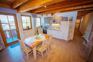 a kitchen and dining room with a table and chairs at Ferienhaus Bührer in Freiamt