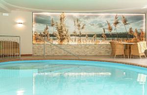 a large swimming pool in a room with a painting at Alpenhof Lodge Almrose iii in Saltusio