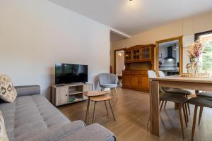 a living room with a couch and a table at Susurros de río in Ocejo +22 photos